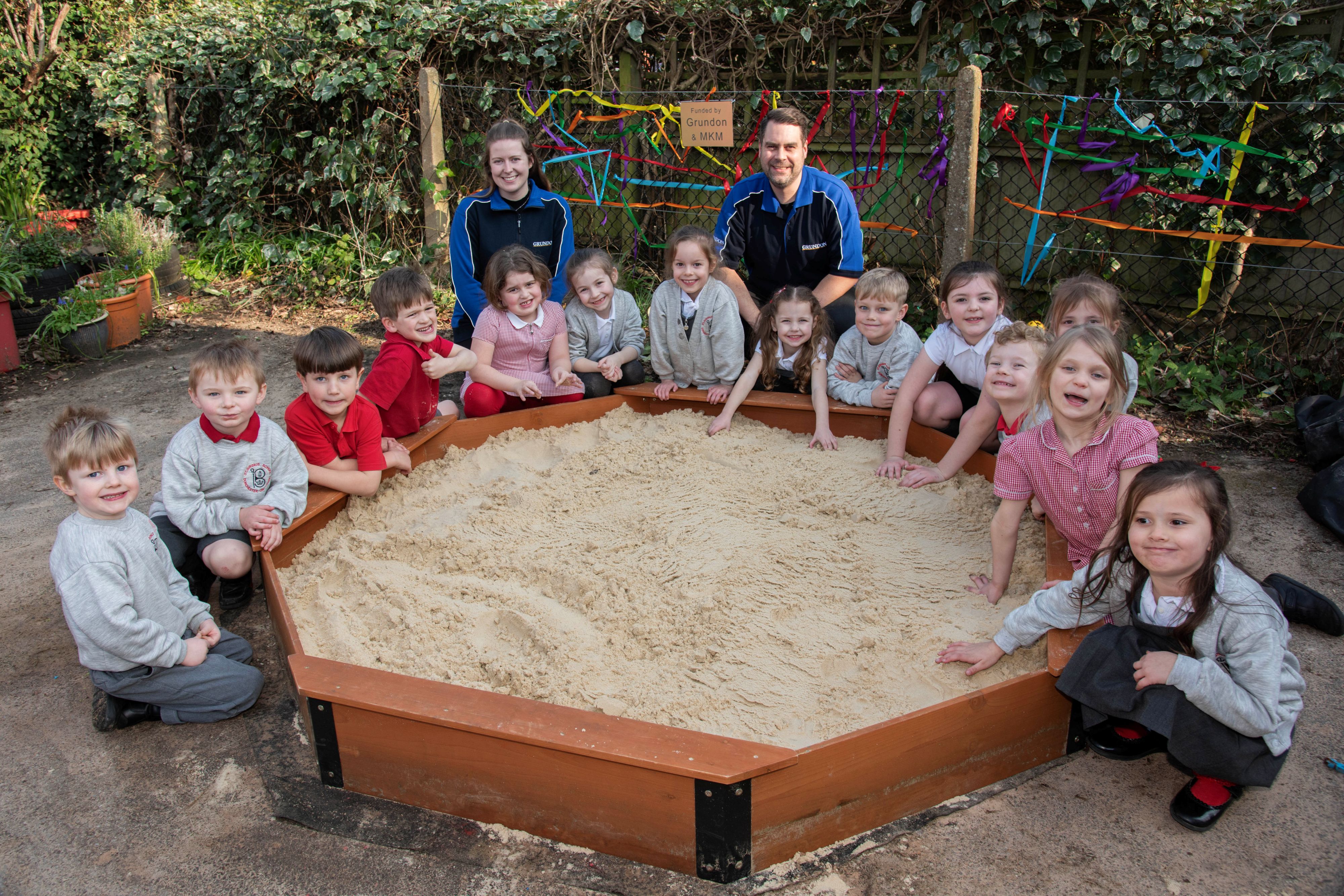 The pupils gather around the new sandpit, joined by Grundon’s Annie Sessions and Chris Cowper.